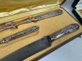 three knives in a case on a table