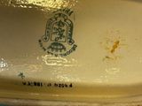 a close up of a blue and yellow vase on a table