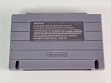 an old nintendo game console sitting on top of a white table