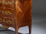 a small chest of drawers with a marble top