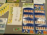 a table with a lot of stamps and postcards on it