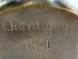 a close up of a silver plate with writing on it