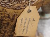 a teapot with a tag on it sitting on a table