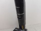 a vacuum that is sitting on the floor next to a wall