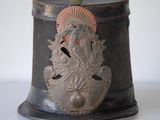 a small metal container with a bird on top of it
