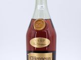a bottle of hennesy brandy on a white background