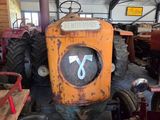 a tractor that is sitting in a room with other tractors