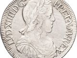a silver coin with a woman ' s head on it