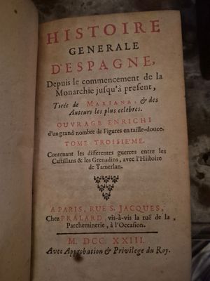 an old book that is open on a table