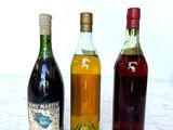 three bottles of wine sitting on a marble table