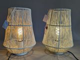 pair of white bamboo lamps on a table with a black cord
