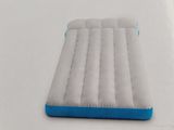 an inflatable air mattress sitting on top of a white table