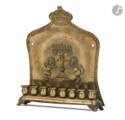 an ornate brass plate with a menorah and five candles on it
