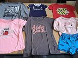 a lot of t - shirts that are sitting on a box