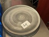 a stack of plates sitting on top of a metal table