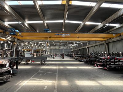 a large warehouse with a lot of cars parked in it