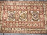 an antique persian rug with a medallion design on a red ground