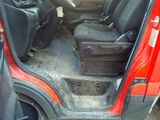a red car with the door open and the seats down