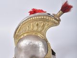 an image of a helmet with a red feather on top of it