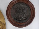 a gold medal and a bronze medal on a white table