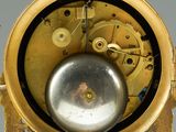 a gold clock with a silver ball in the middle of it