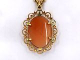 an image of a pendant with an orange stone in the center
