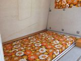 a bed in the middle of a room with flowers on it