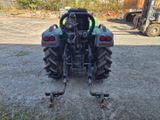 a tractor that is parked in the dirt