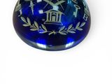 an image of a blue glass paperweight on a white background