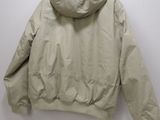 an image of a jacket hanging on a hanger on a wall