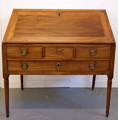 an old wooden desk with three drawers and a drawer on top of it