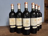 six bottles of wine sitting on top of a wooden table