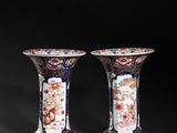 pair of chinese vases on a black background with a black background