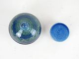 a blue bowl and a blue bowl on a white surface