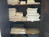 a cabinet with a lot of folded towels in it