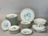 a lot of plates and bowls sitting on a table