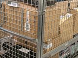 a metal cage with a laptop on top of it