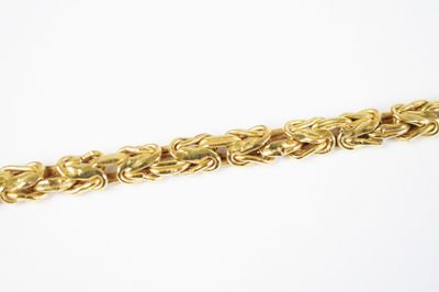 a close up of a gold chain on a white background