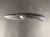 a knife on a table with a tag on it