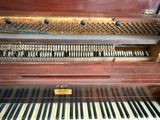 a piano that is sitting inside of a wooden case