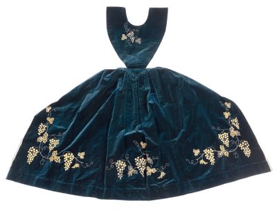 a green velvet dress with gold embroidered flowers on it