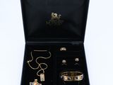 a black box with a necklace, bracelet, and ring in it