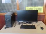 a desktop computer sitting on a desk with a keyboard and mouse