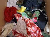 a cardboard box filled with clothes and other items