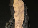 leather jacket on a mannequin head on a black background