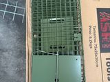 a box with a cage on top of it on the floor