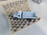a toy truck that is sitting in a cardboard box