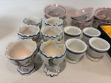 many cups and saucers sitting on a table