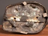 a metal object that is sitting on a wooden table