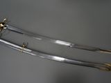 two swords with a gold handle and a black handle
